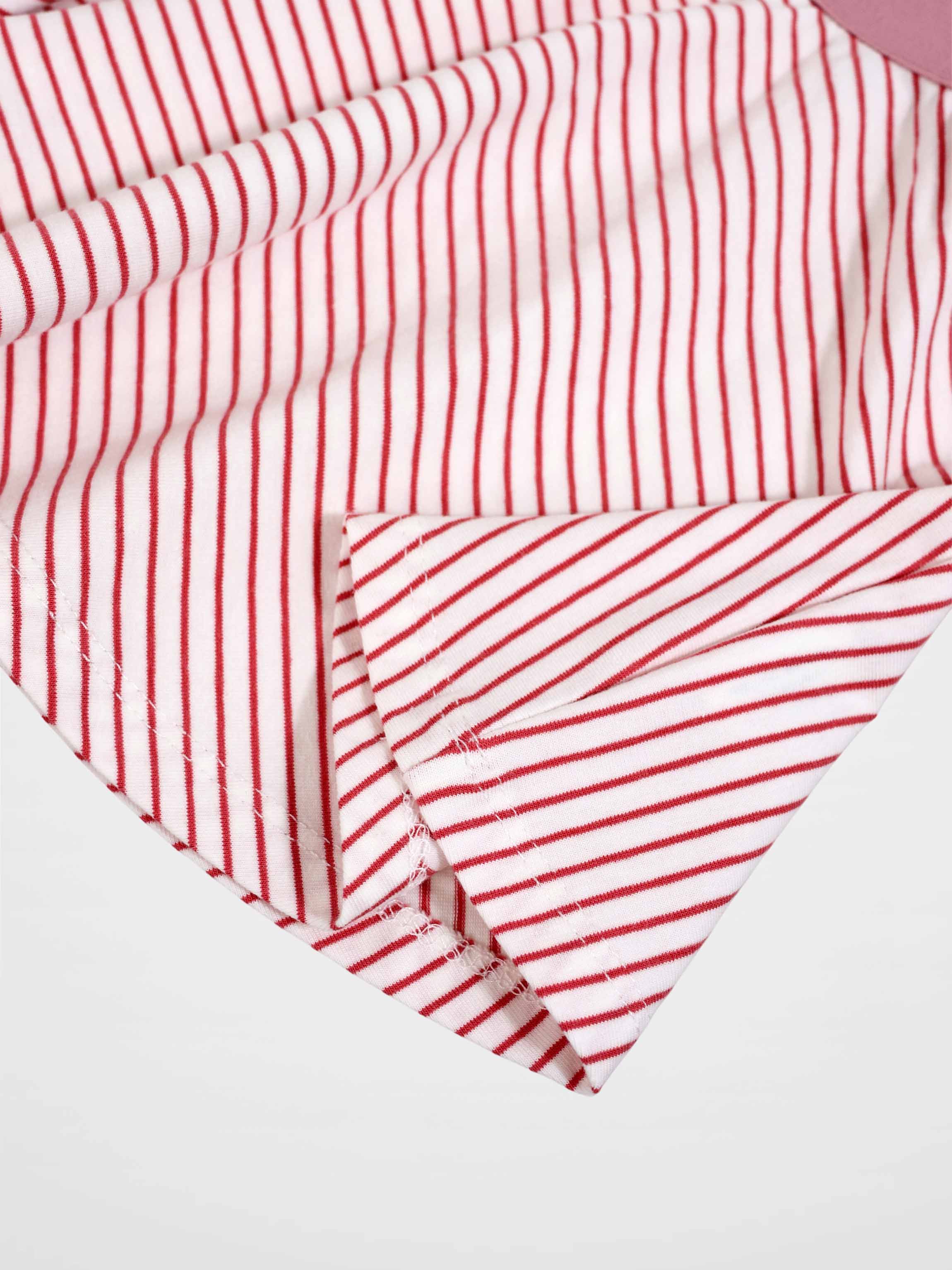 Striped pink girls skirt close-up fabric with red stripes on white background
