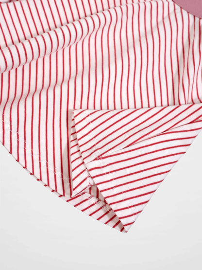 Striped pink girls skirt close-up fabric with red stripes on white background