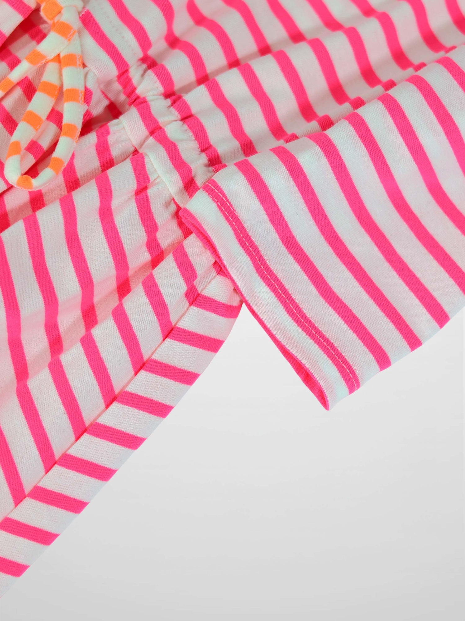Neon pink and white striped dress with 3/4 sleeves and a gathered waist in knit fabric.