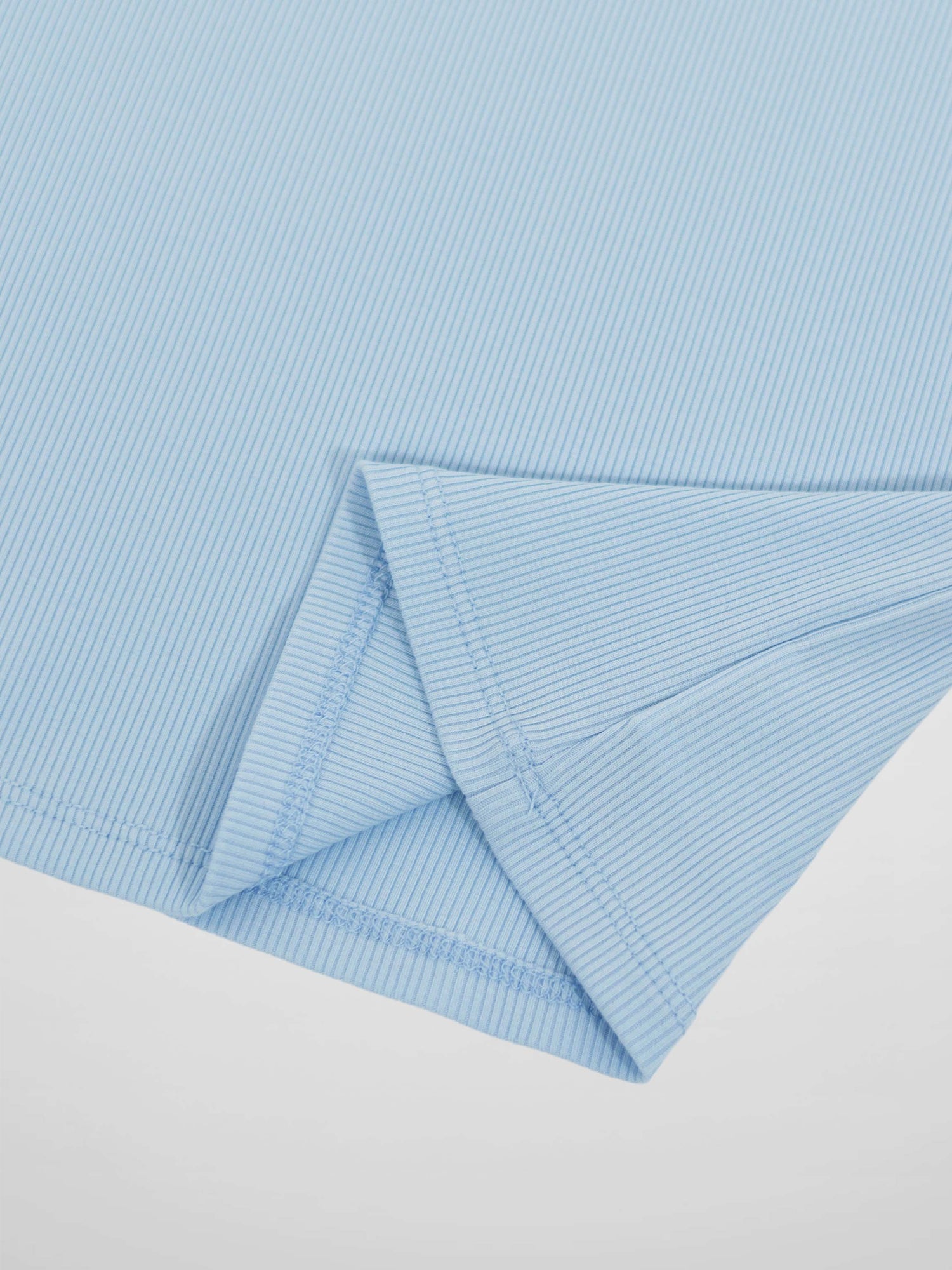 Light blue 3/4 puff sleeve T-shirt close-up of folded cuff.