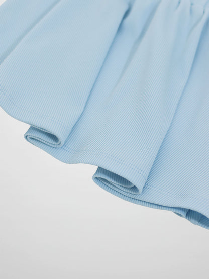Light blue paper bag waist skirt with ribbed fabric and soft folds.