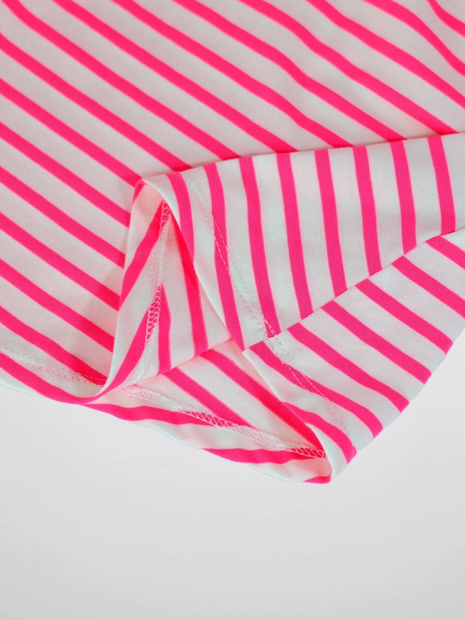 Neon pink and white striped fabric from a short-sleeve dress, with visible stitching along the hem.