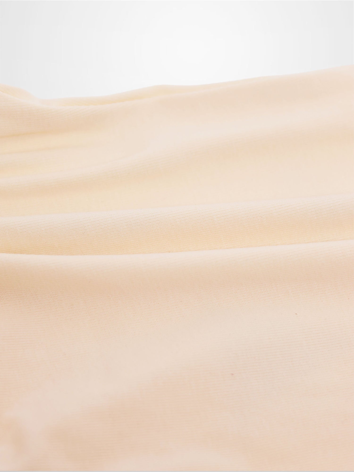 Soft peach fabric close-up for Sail Boat Romper, subtle knit texture.