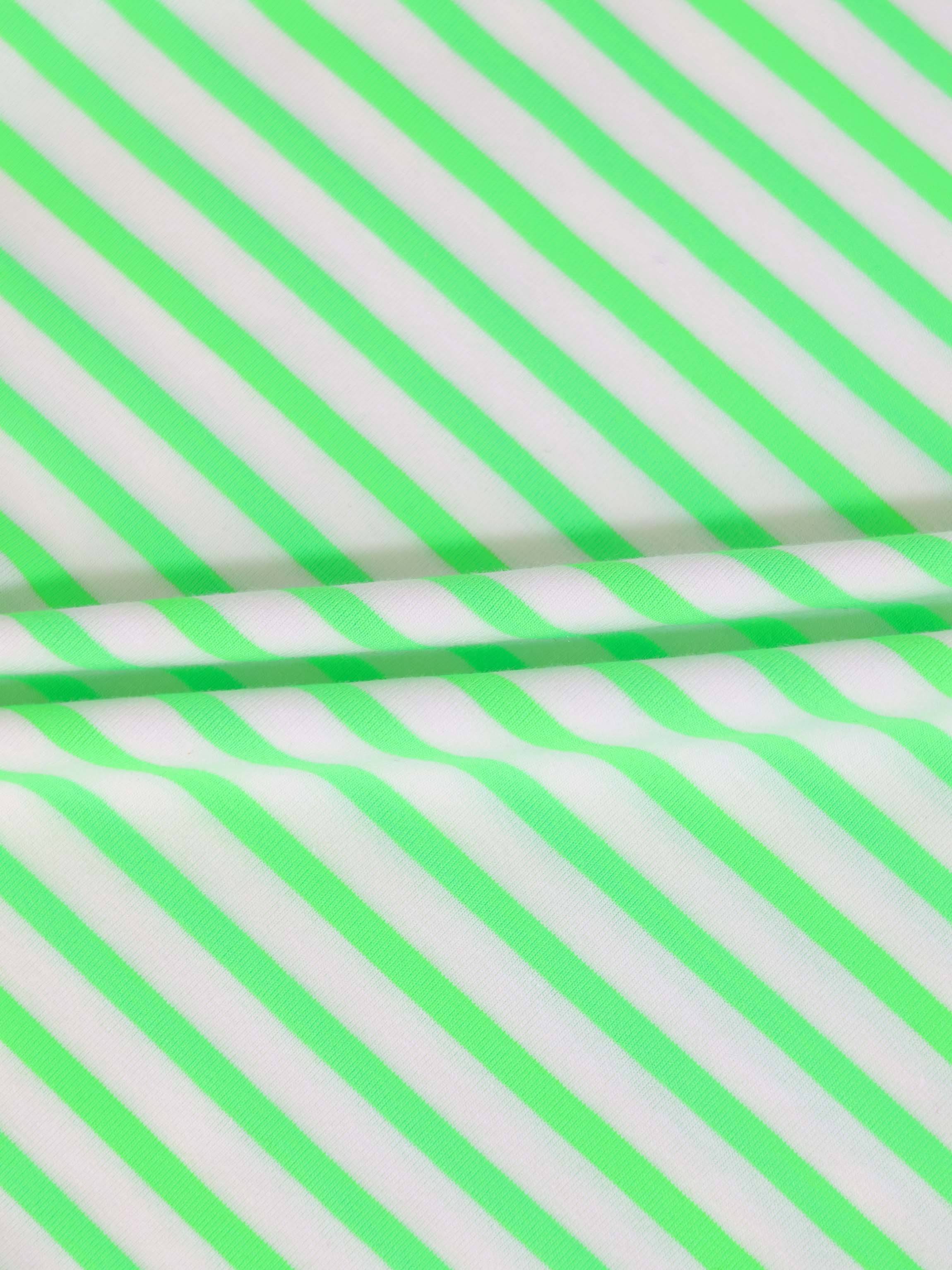 Close-up of neon green diagonal striped fabric for a romper.
