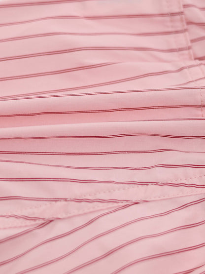 Close-up of pink striped cotton shorts fabric with visible stitching.