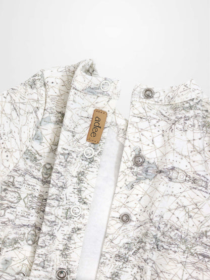 Map Stretchy baby jumpsuit footie in off-white with sage map print, compass markers, and crossover detail.