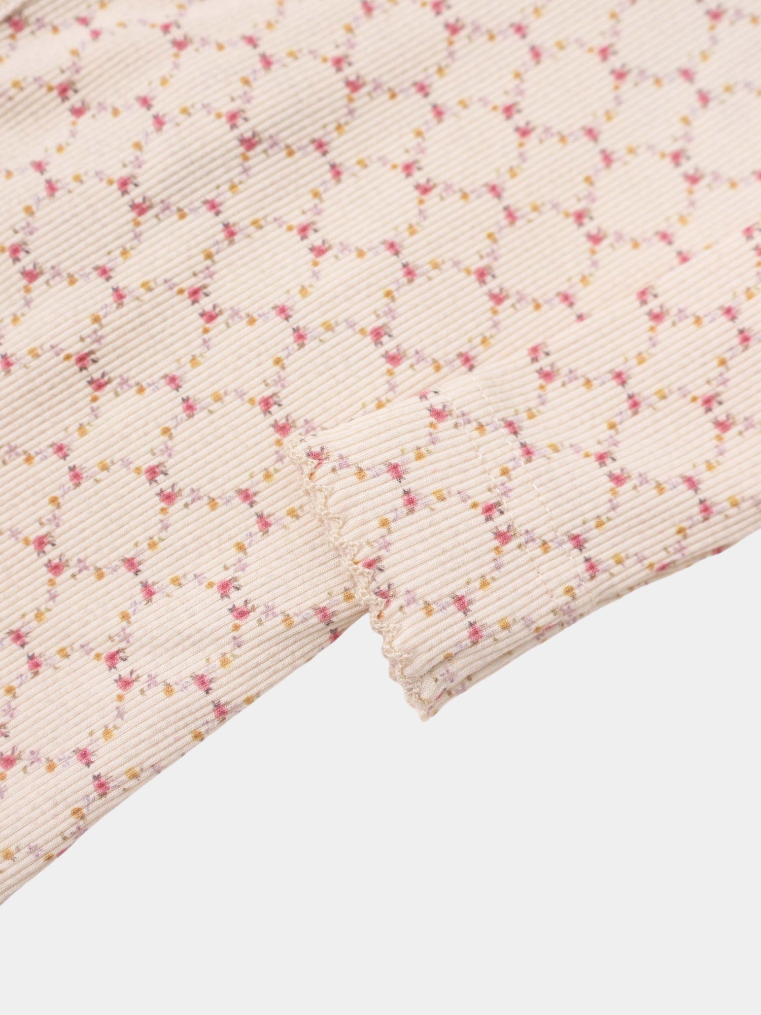 Floral Garland layette set by Adee; pale pink ribbed knit fabric with tiny pink and yellow floral garlands.