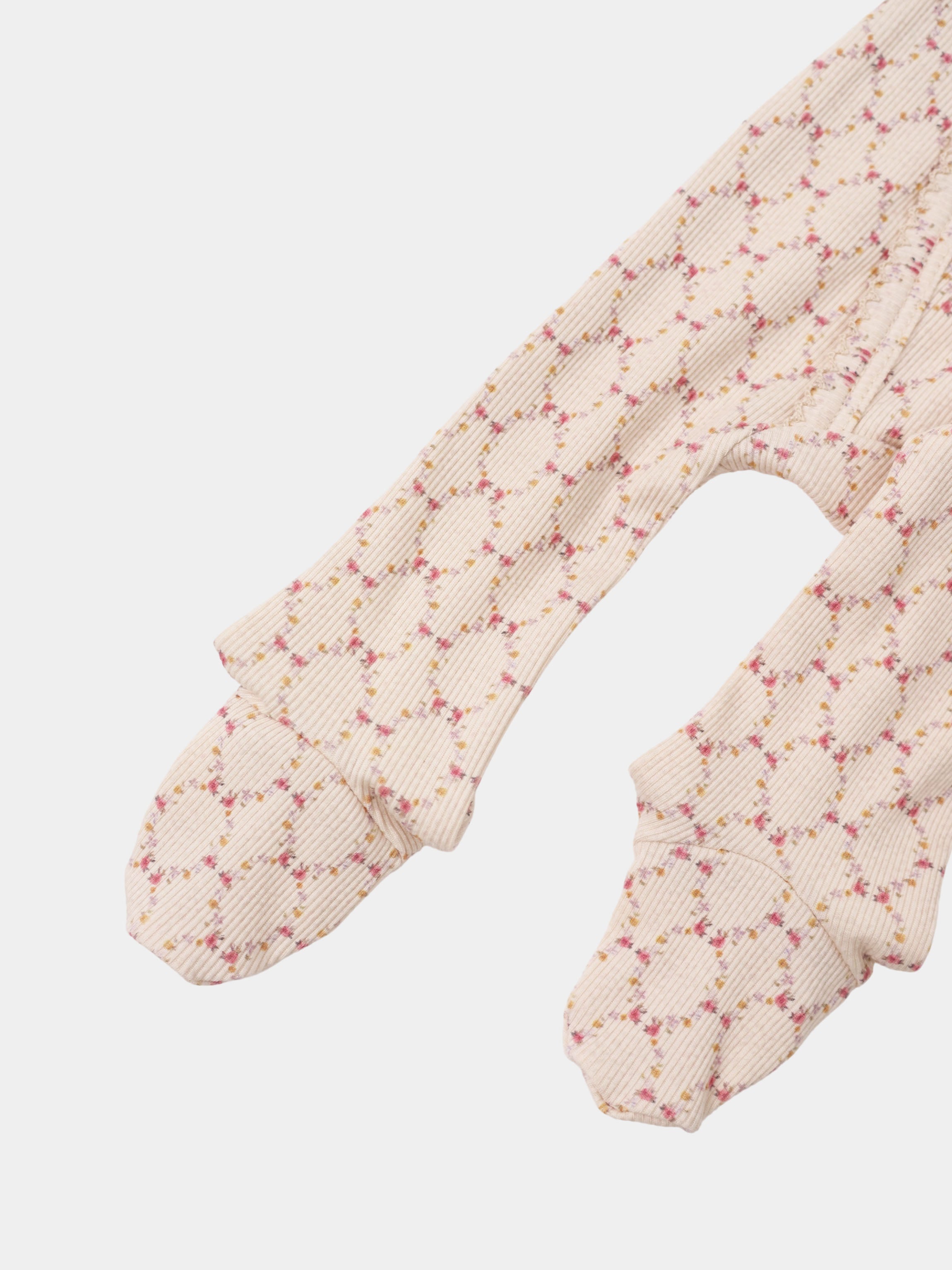 Floral Garland layette set by Adee; beige ribbed fabric with pink and yellow floral garland pattern on baby sleeves
