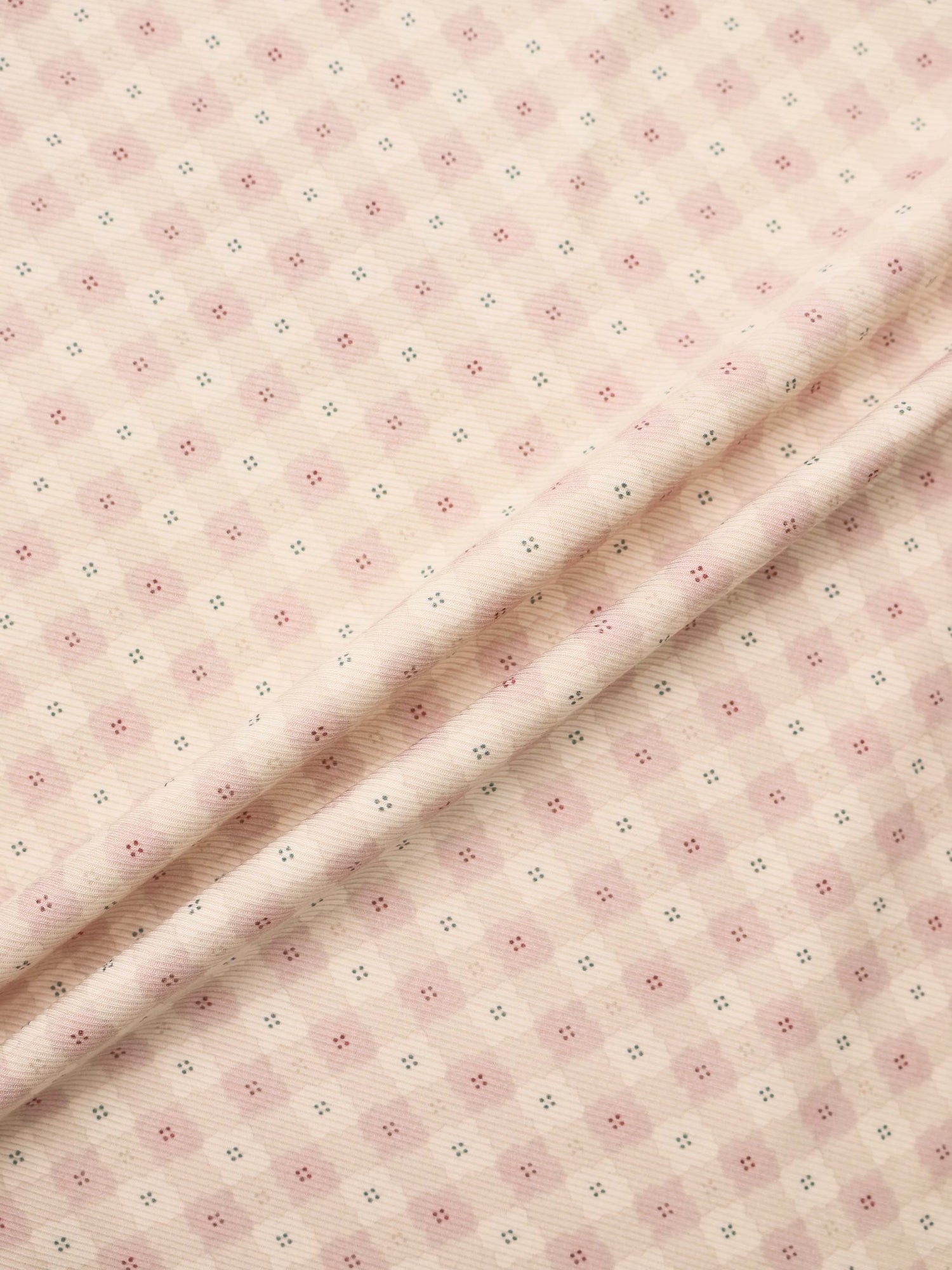 Little Button Pink Layette Set fabric; soft pink with tiny pink floral clusters and teal accents