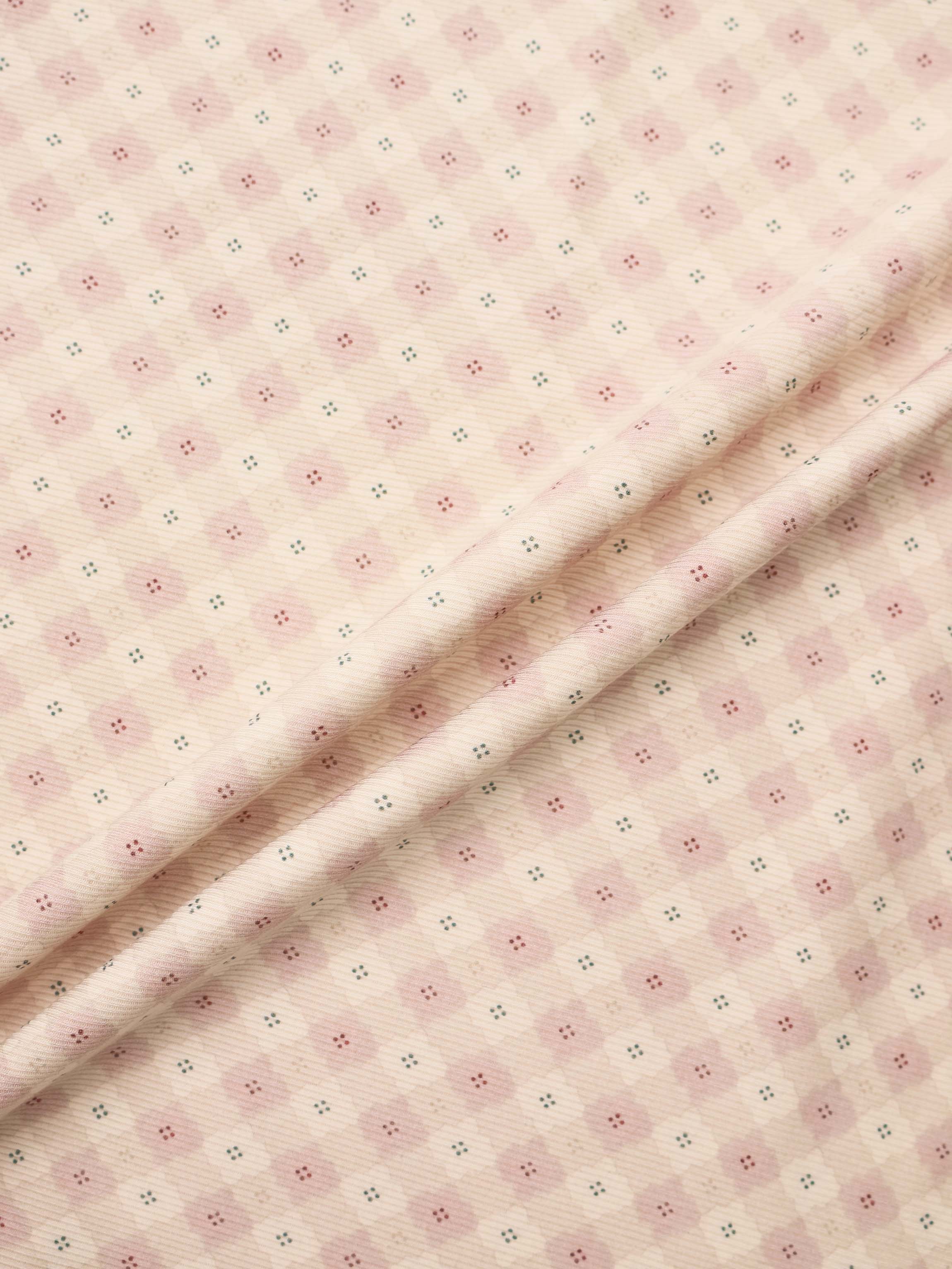 Little Button Pink Layette Set fabric; soft pink with tiny pink floral clusters and teal accents