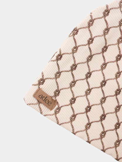 Brown Chain layette set for boys by Adee, beige ribbed fabric with brown lattice chain pattern and visible brand tag