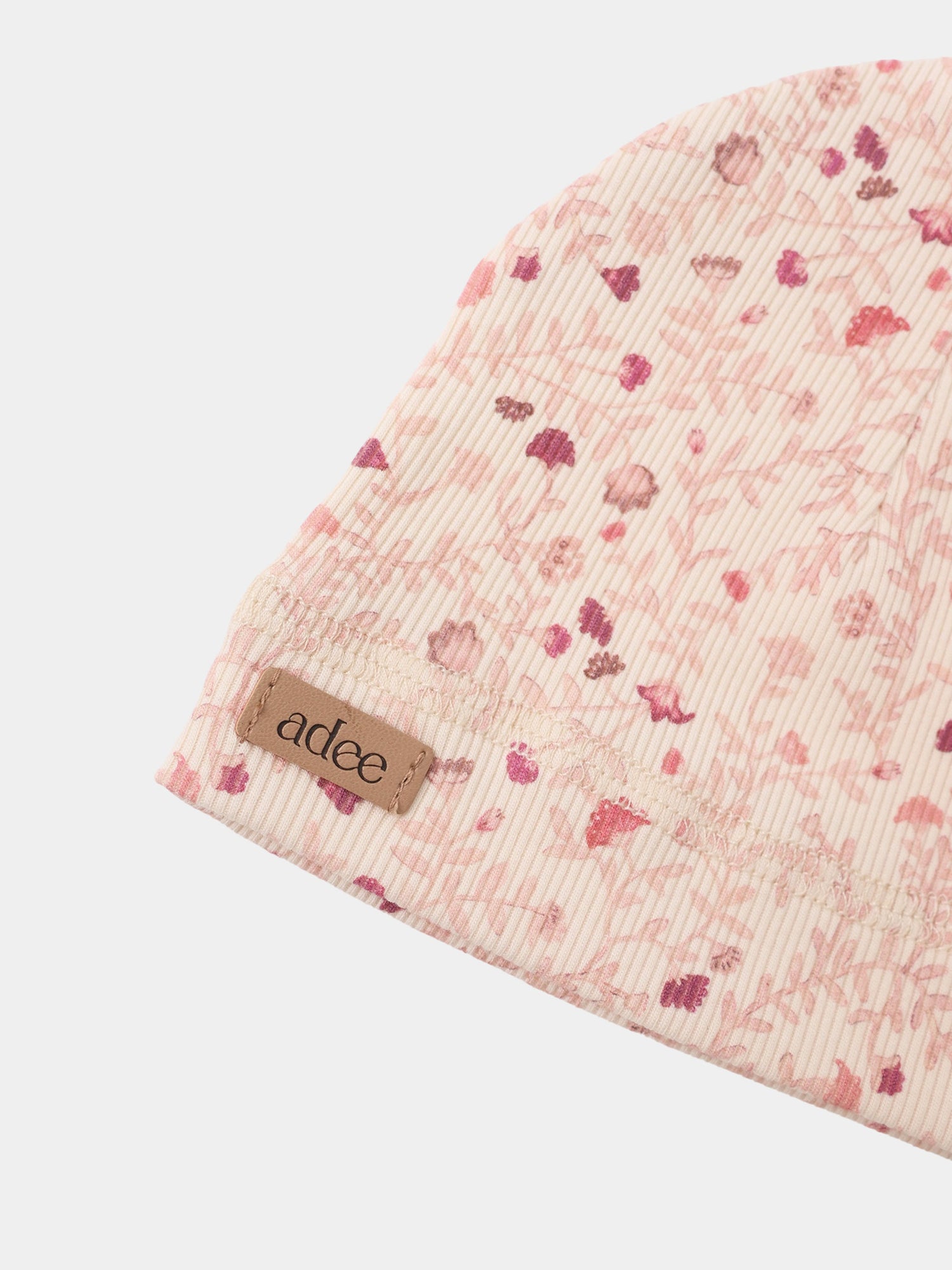 Garden Sprinkles layette set in pink floral ribbed fabric with visible Adee label