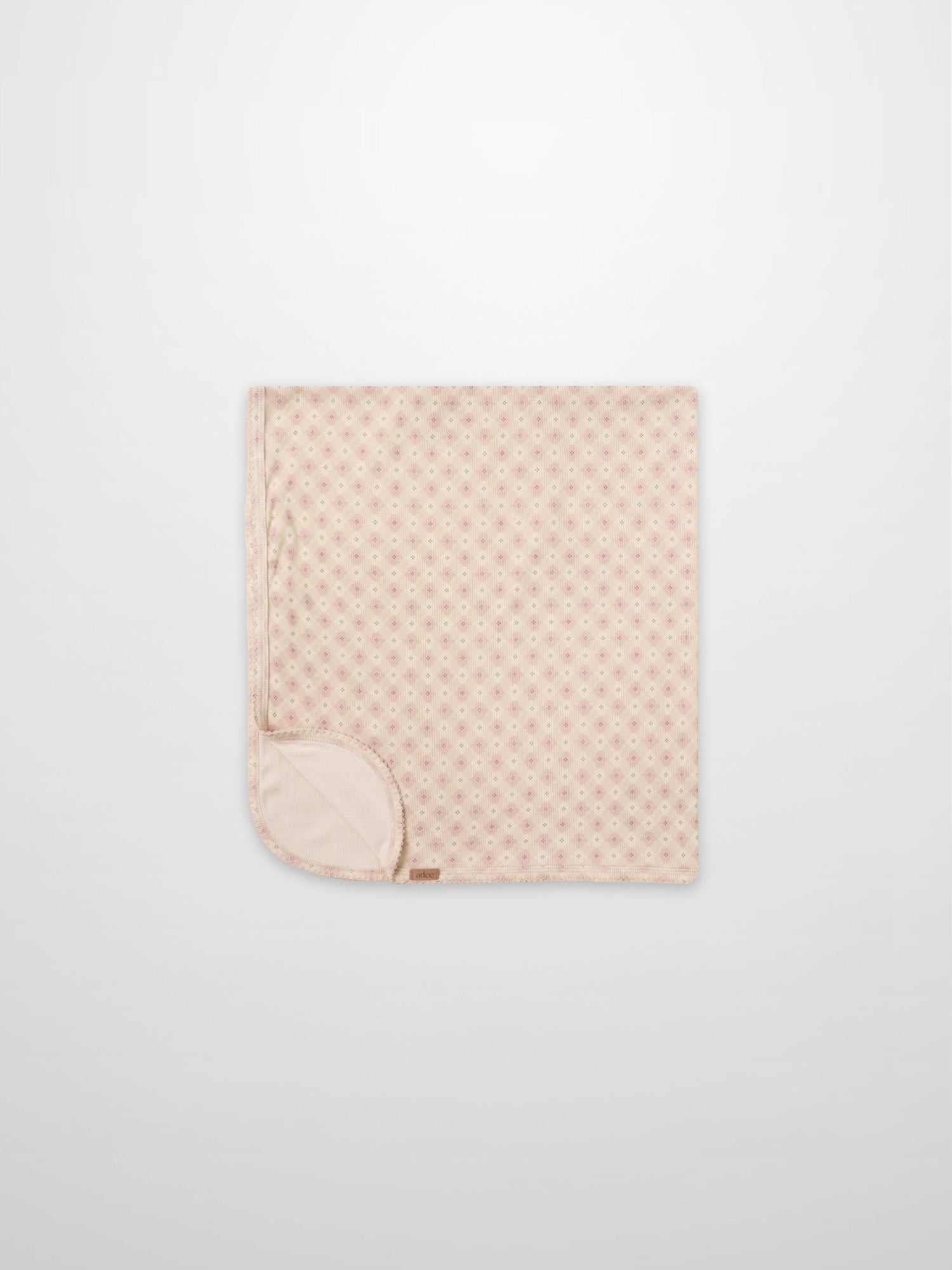 Little Button Pink layette set by Adee; pink baby blanket folded with tiny dot pattern