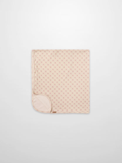 Little Button Pink layette set by Adee; pink baby blanket folded with tiny dot pattern