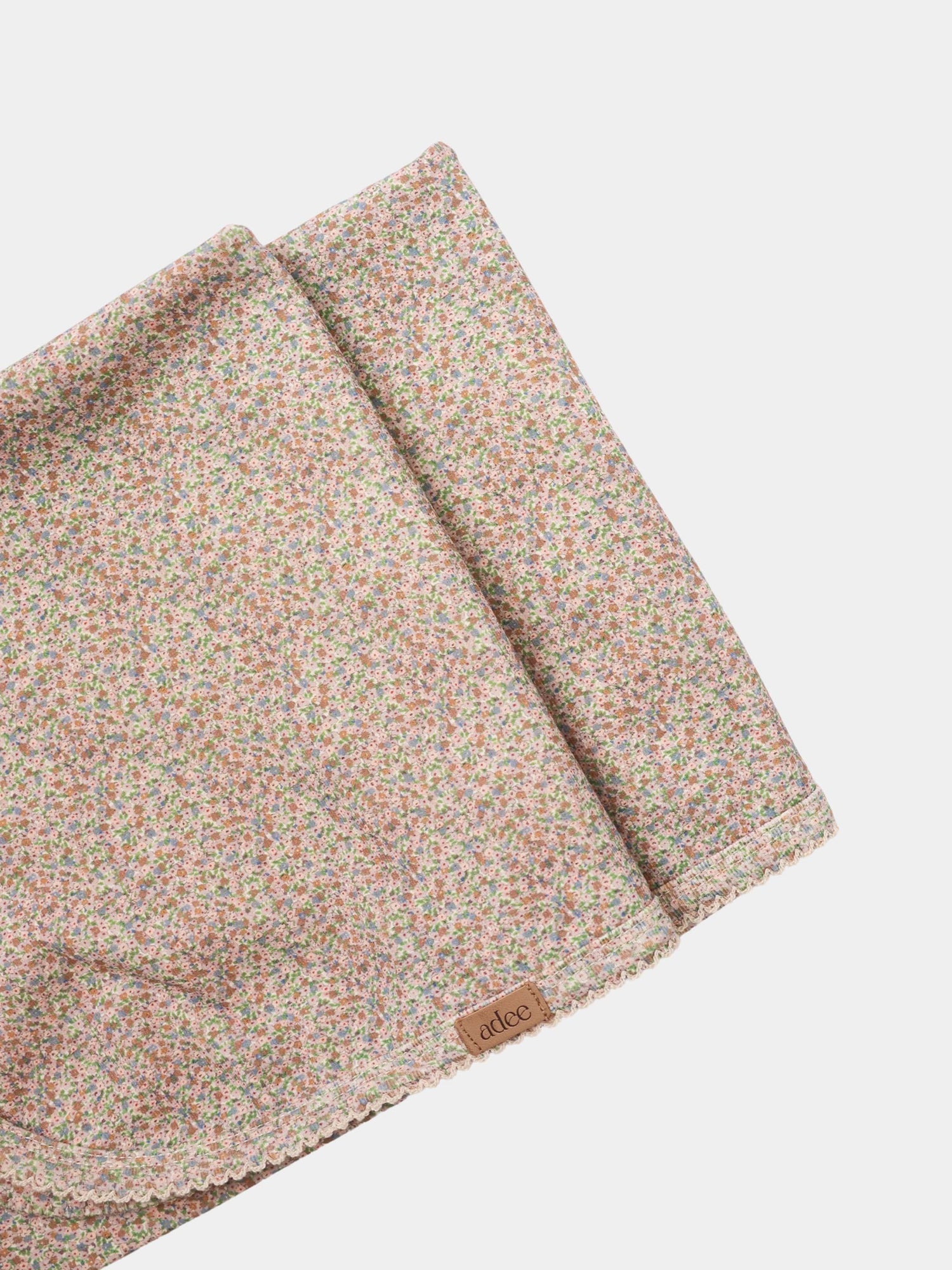 Pastel Petal layette set for girls by Adee; pink floral print with lace trim edges.