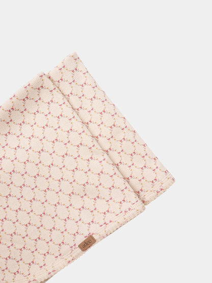 Floral Garland Layette Set by Adee, peach quilted blanket with pink and yellow floral pattern