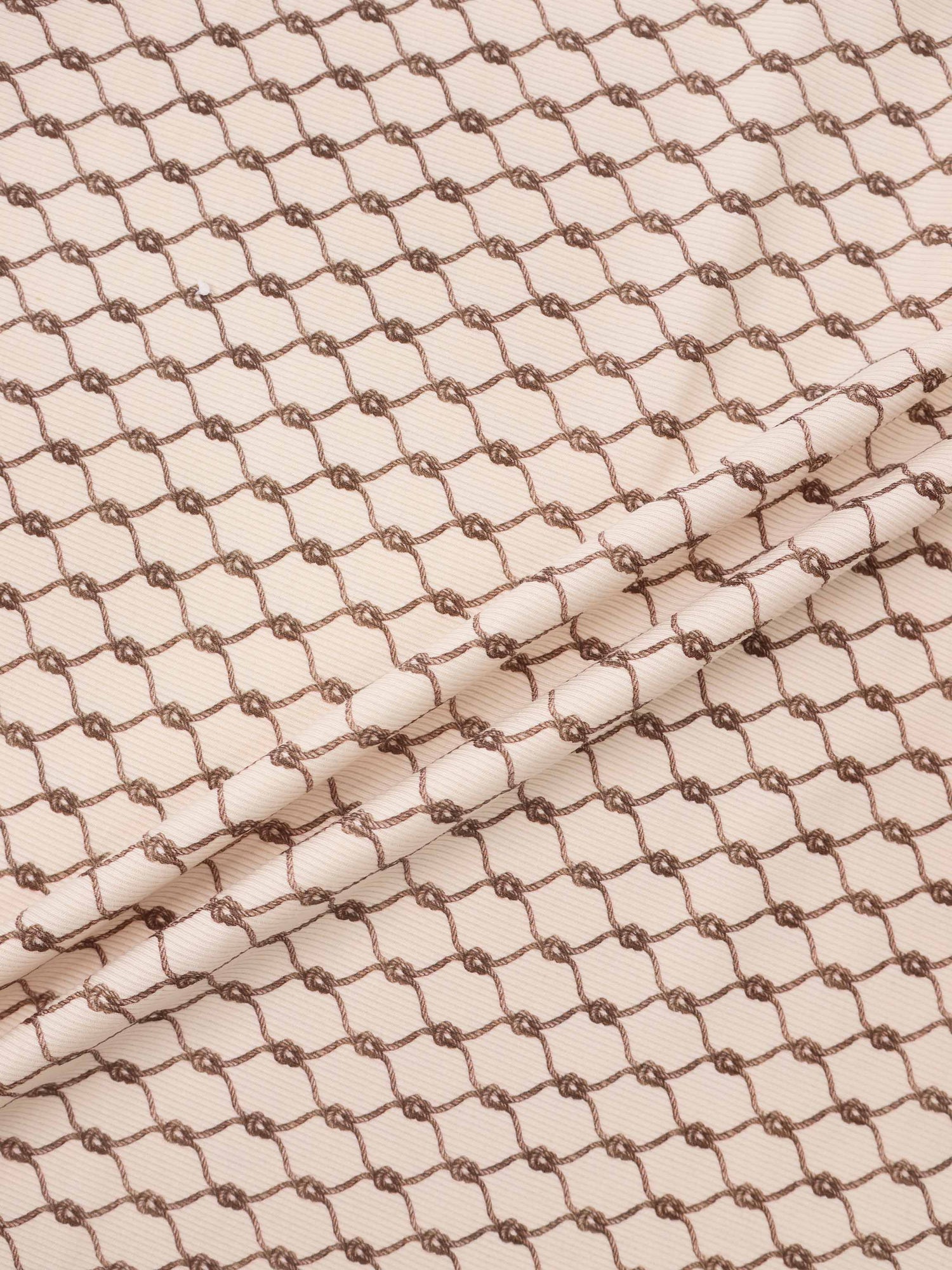 Brown Chain Layette Set fabric by Adee; beige base with brown chain pattern for boys