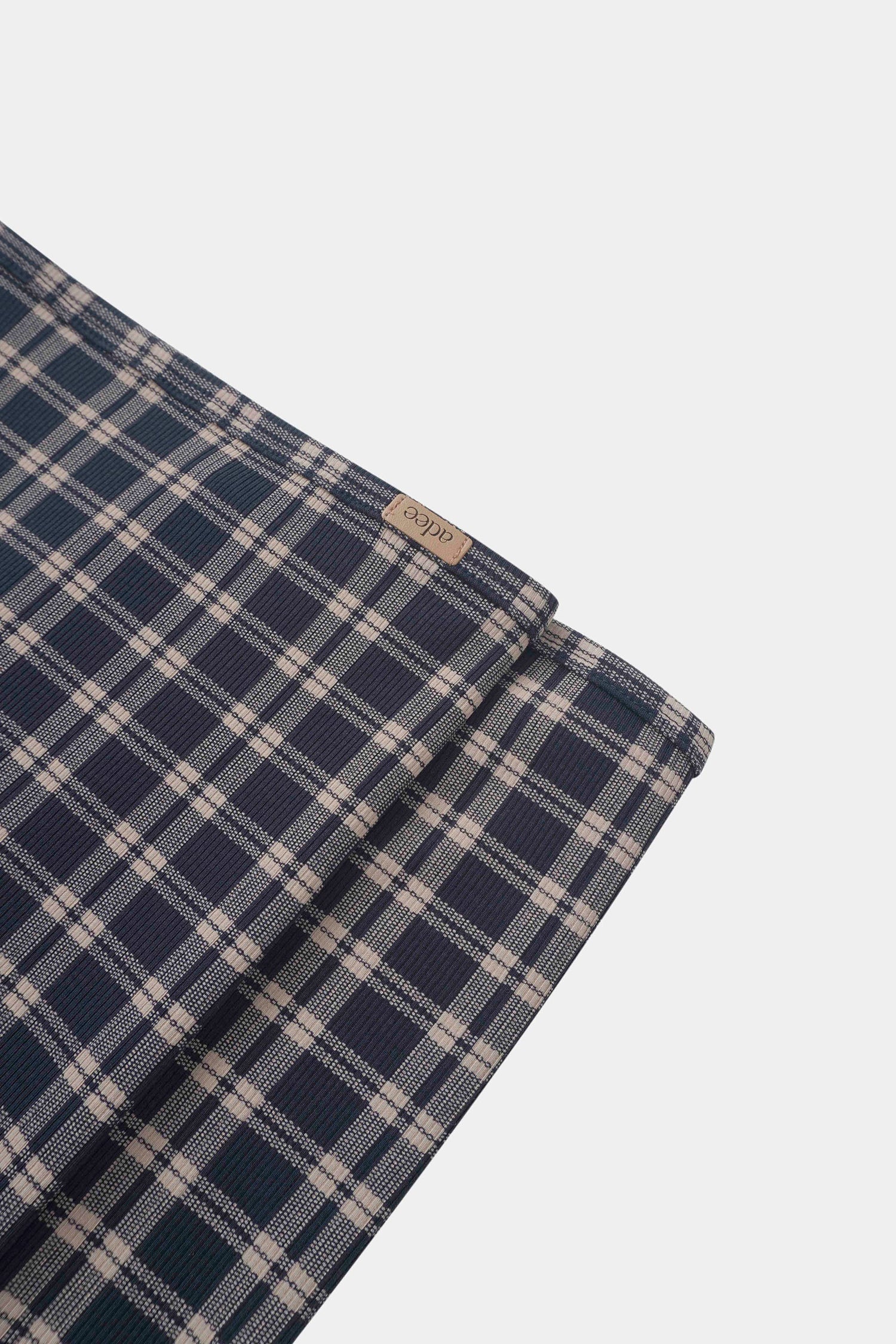 Navy plaid layette set for boys by Adee with beige checks and brand tag.