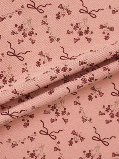 Adee Bow Bouquet layette set fabric in pink with burgundy floral clusters and bow motifs