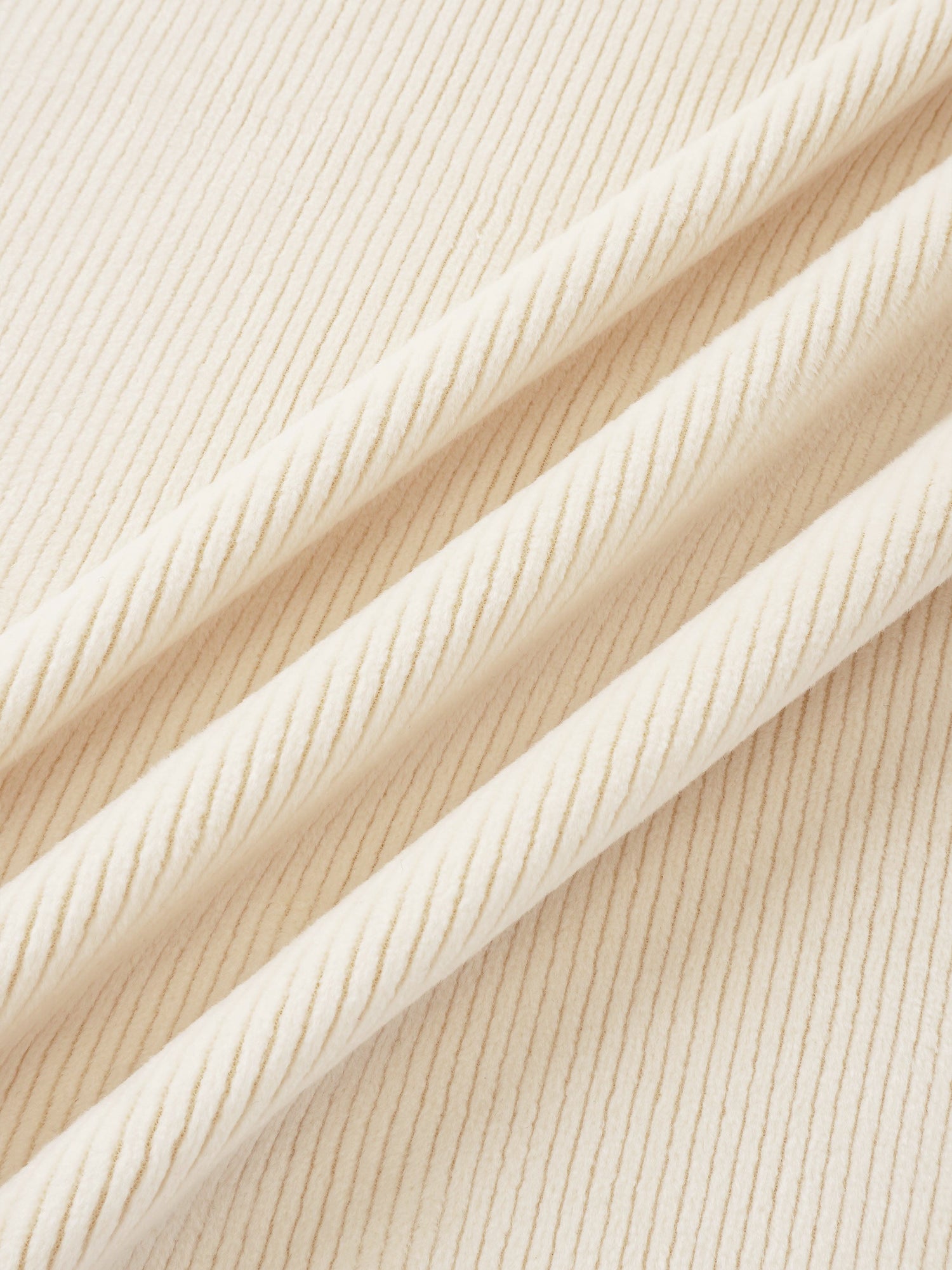 Layette fabric close-up in cream, ribbed knit texture for baby sets