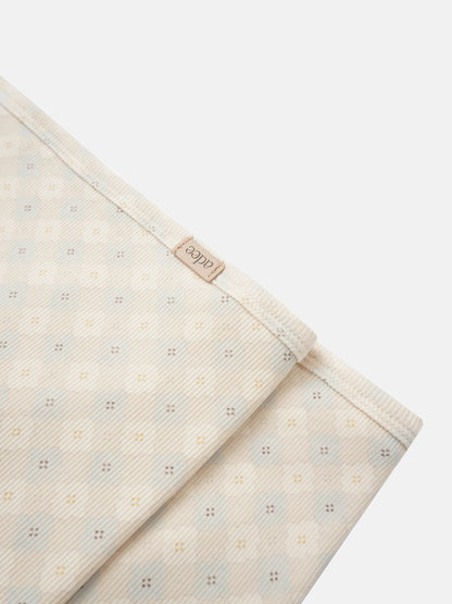 Little Button Blue layette set by Adee; cream fabric with tiny pastel dots and visible Adee tag