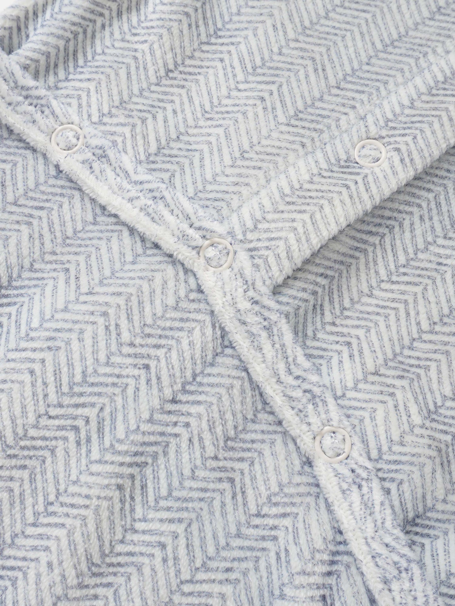 Adee Heritage Herringbone Blue layette blanket for boys with white snap buttons along the edge.