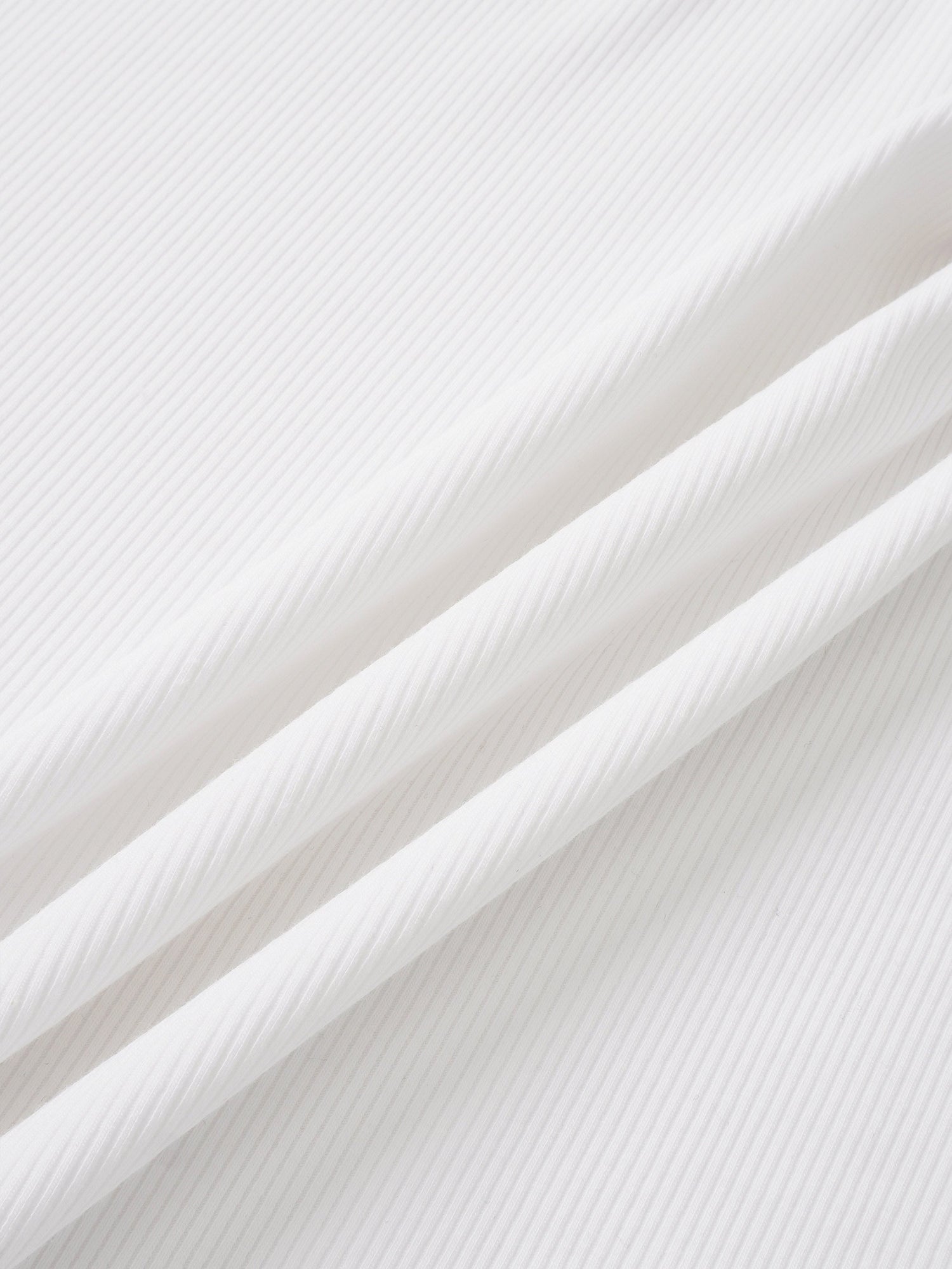 Legacy Stitch White layette set fabric close-up; ribbed cotton.