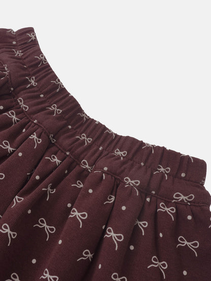 Adee burgundy bow-layered girls skirt with elastic waistband and white bow pattern.