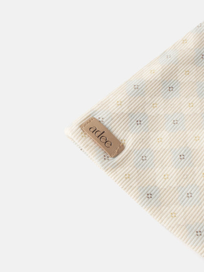 Little Button Blue layette set by Adee; beige striped fabric with tiny pastel cross motifs.