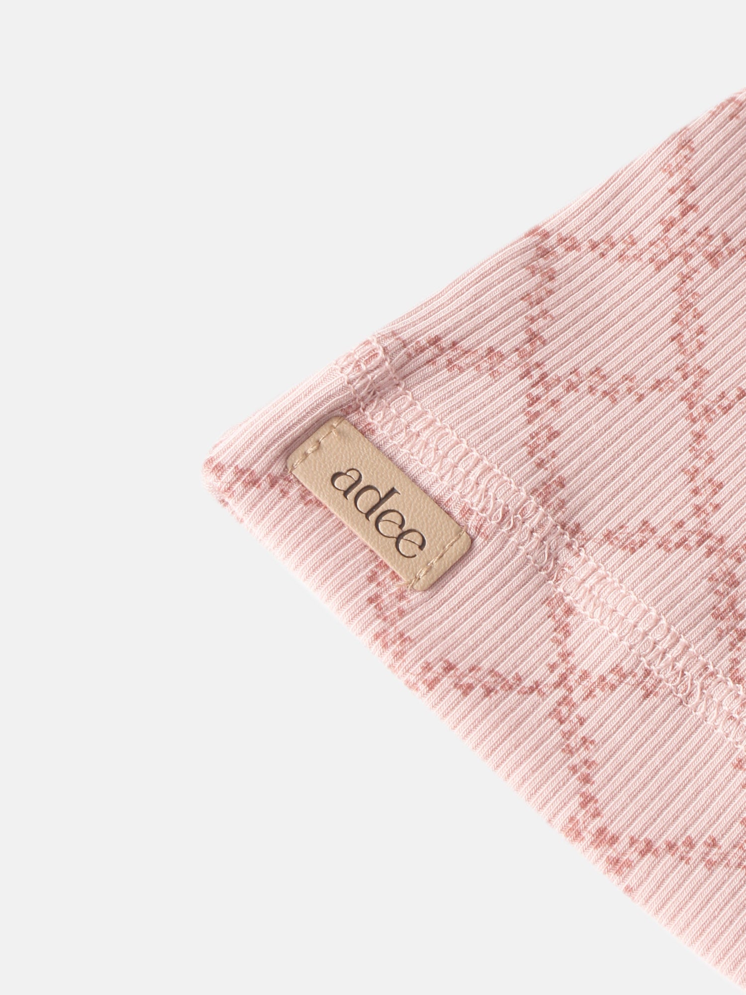 Pink Leaf Layette Set ribbed knit fabric close-up with Adee label