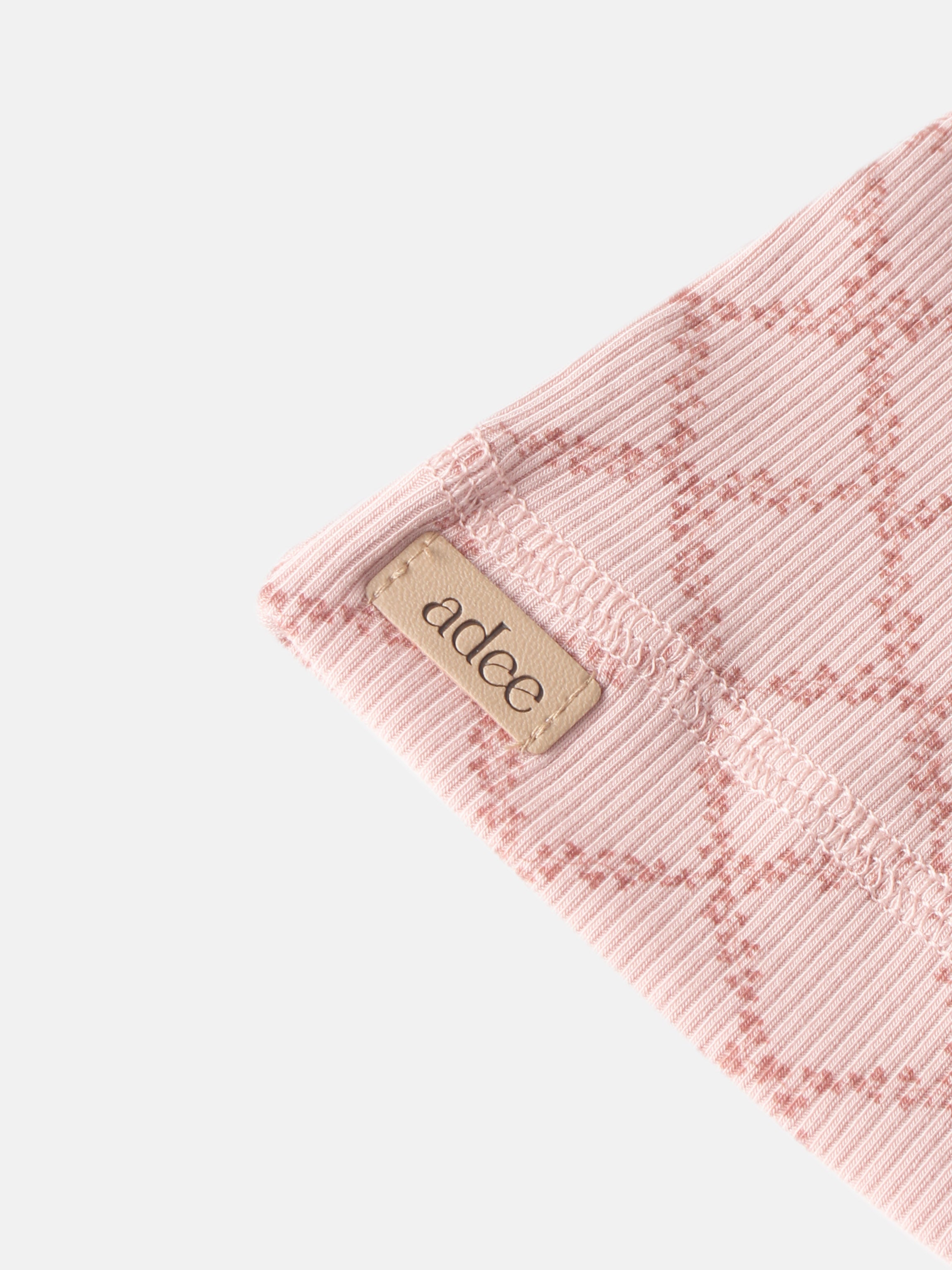 Pink Leaf Layette Set ribbed knit fabric close-up with Adee label