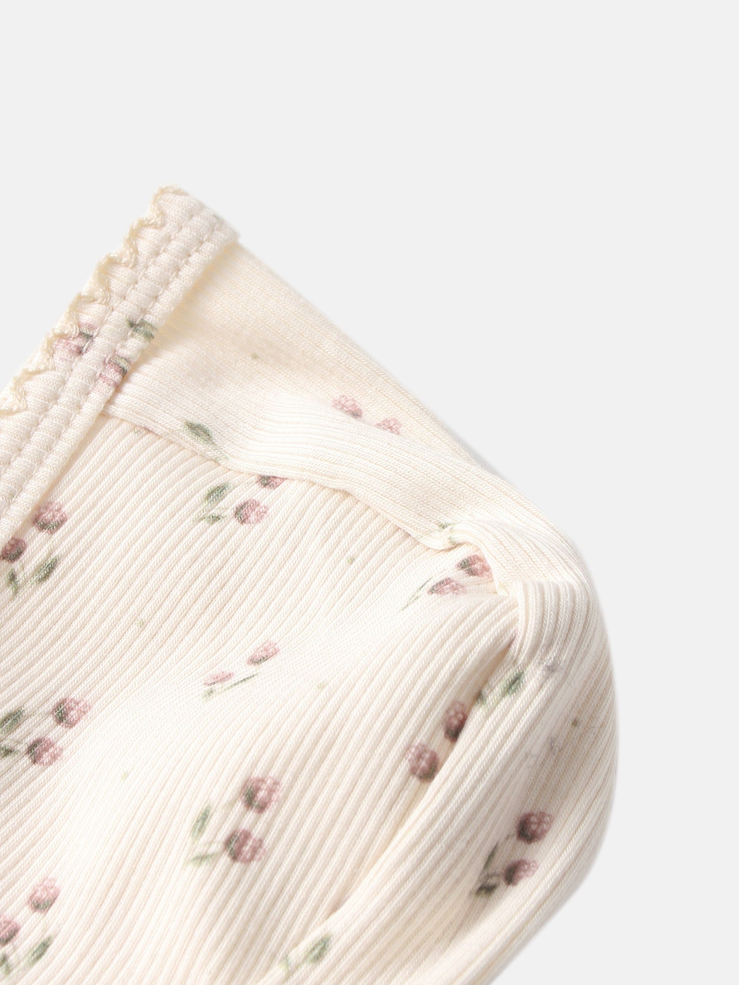 Adee Tiny Tulip layette set top in ivory ribbed fabric with tiny pink floral print.