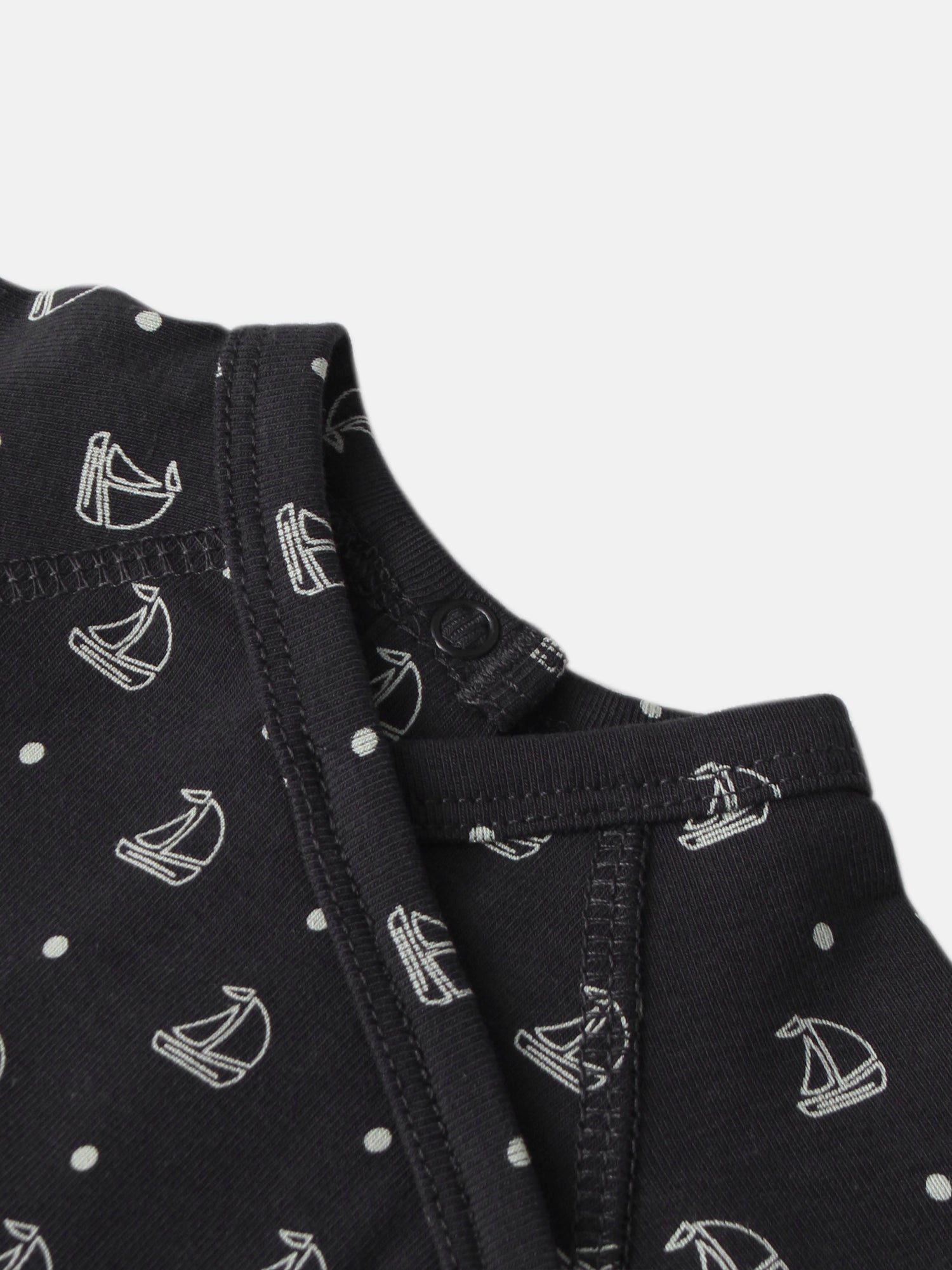 Harbor Dot layette set for boys; navy fabric with white sailboats and polka-dot pattern, close-up stitching.
