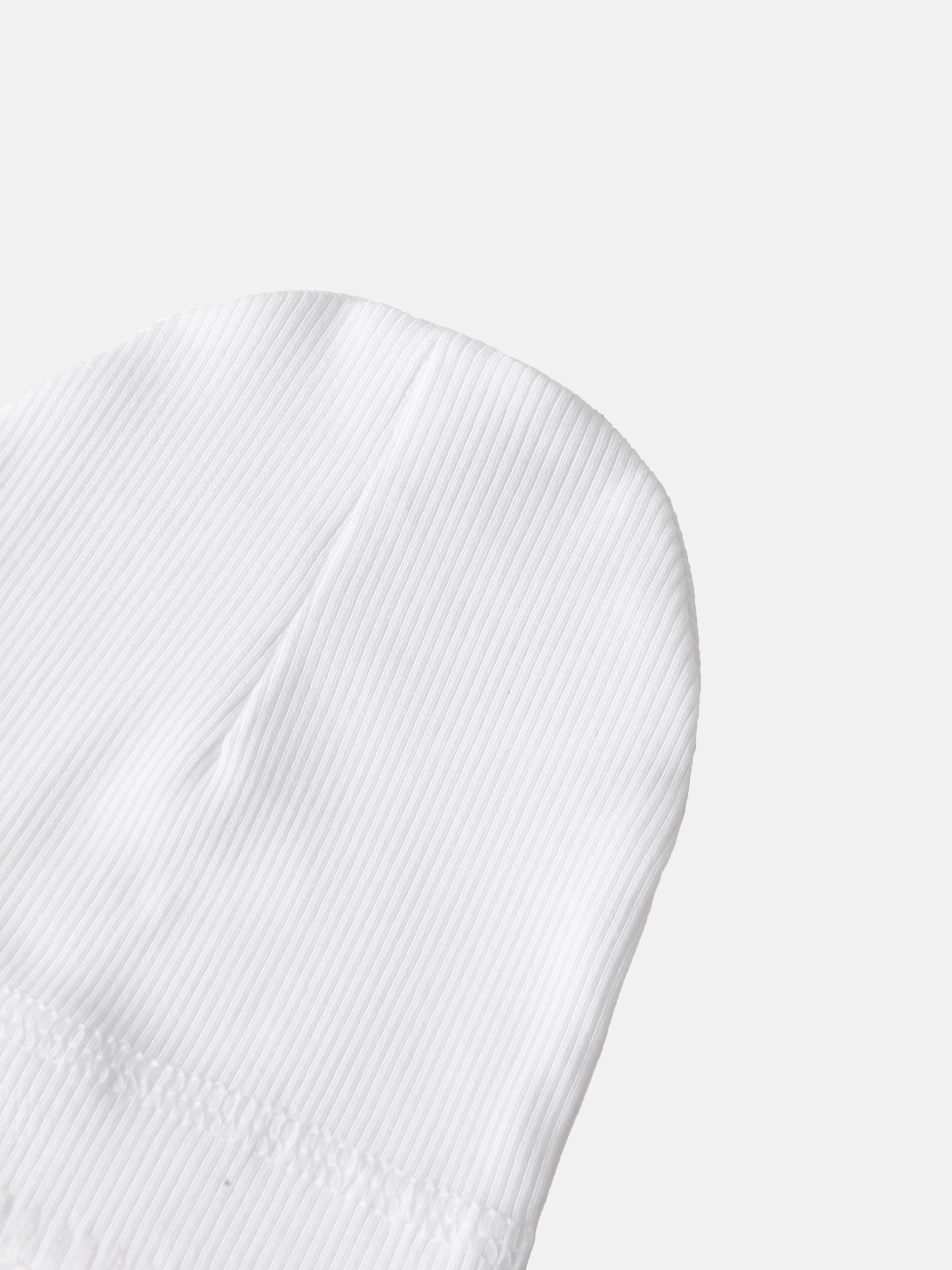 Legacy Stitch White layette set close-up of white ribbed cotton fabric; unisex