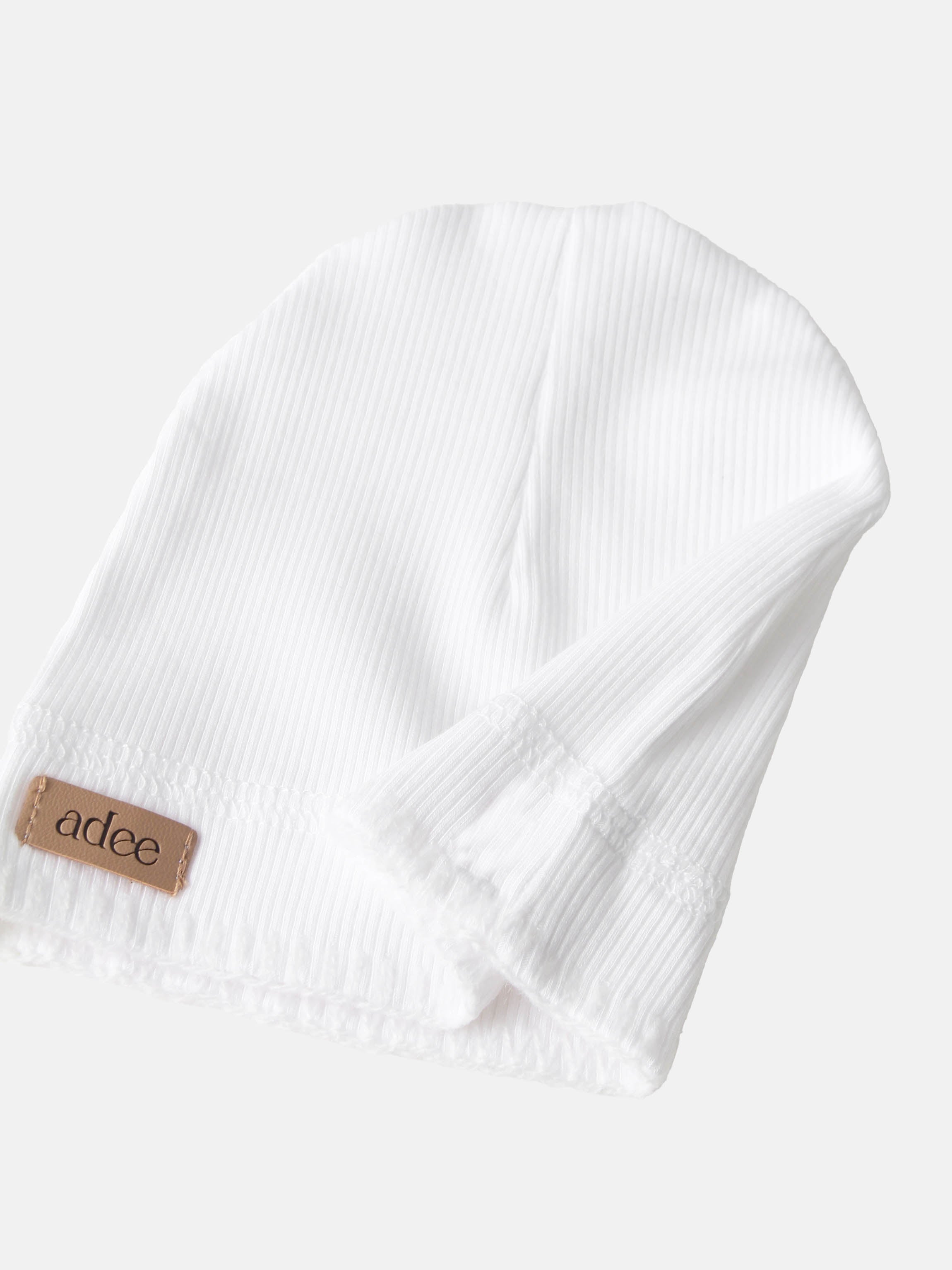 Legacy Stitch White layette set by Adee; unisex baby outfit in white with fine pinstripe and visible brand tag.