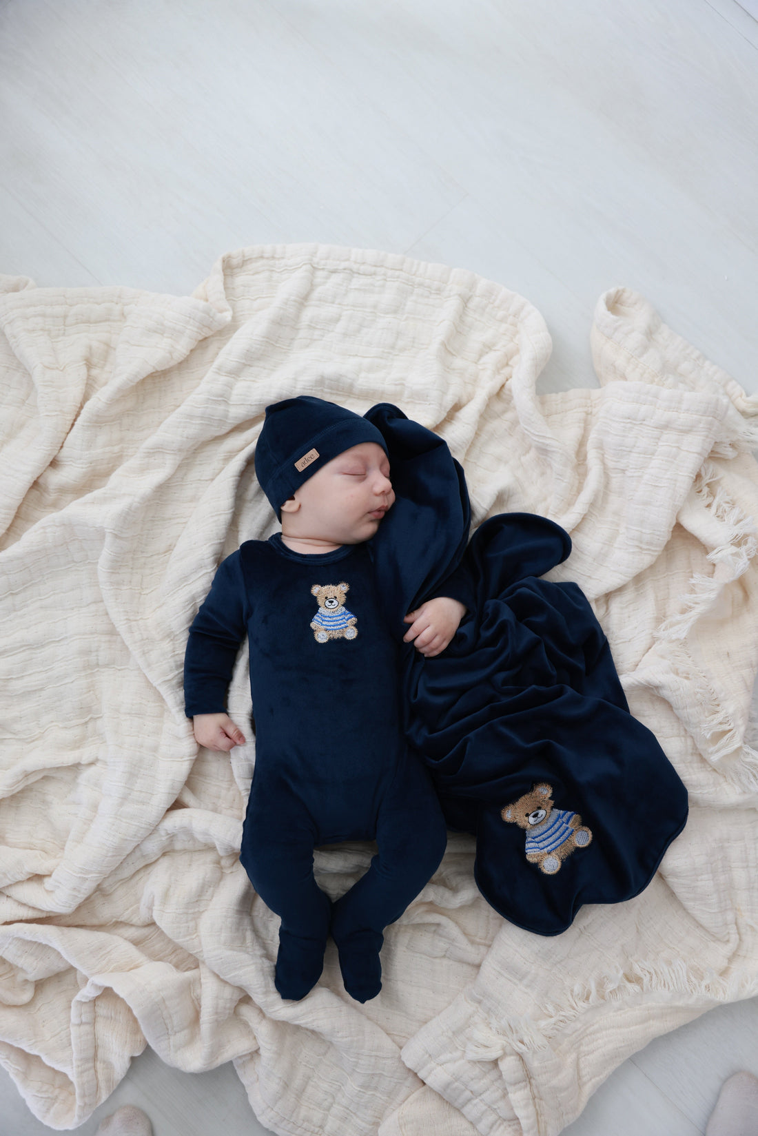 Embroidered Bear Navy layette set for boys by Adee; three-piece navy set with bear embroidery, hat and swaddle blanket.