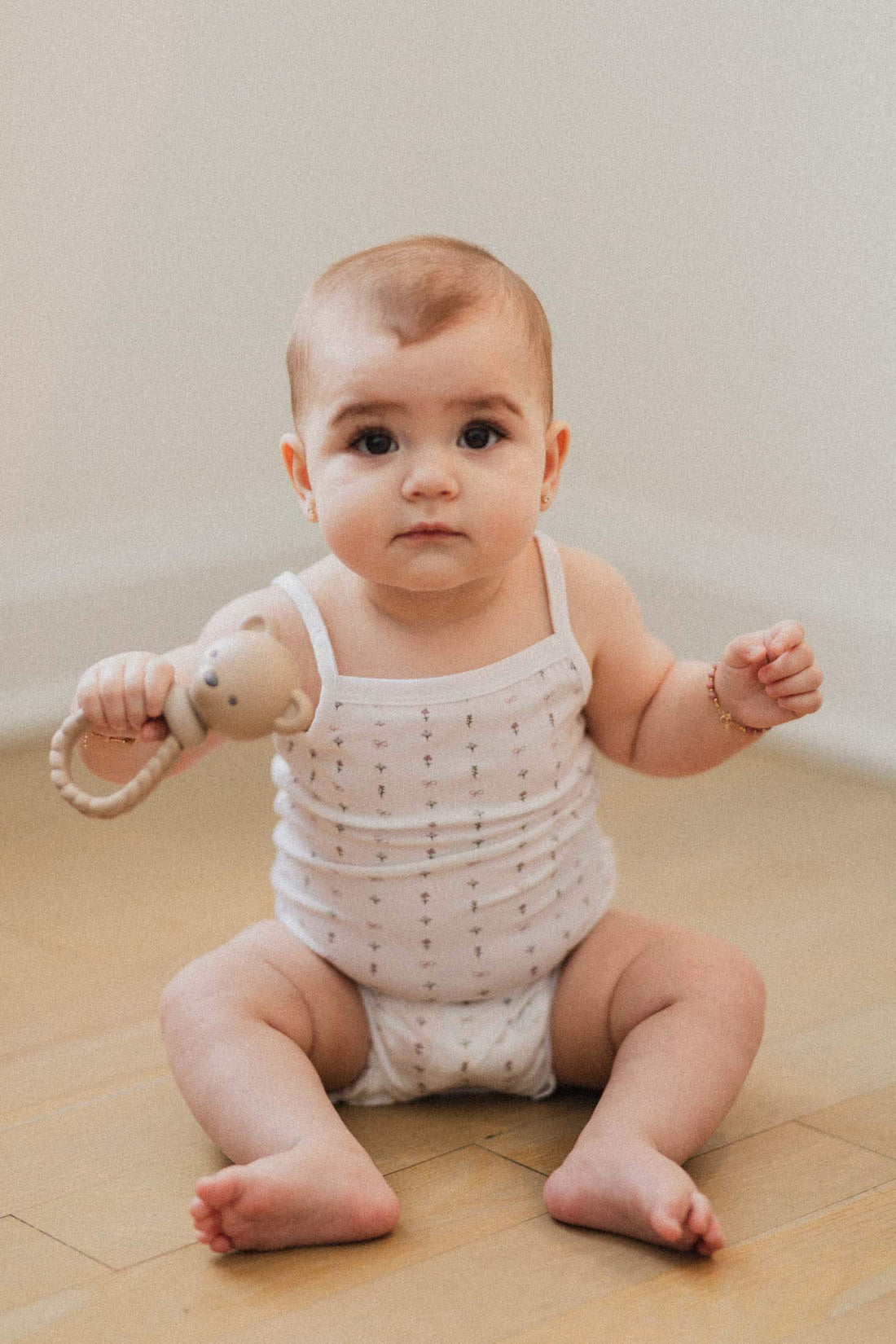 Adorable baby in white bodysuit